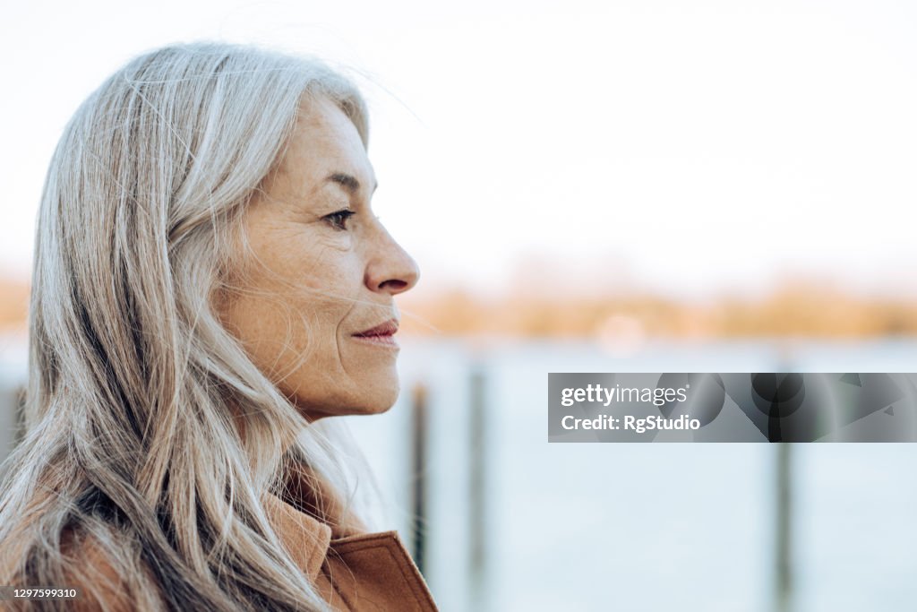 Headshot of a thoughtful mature woman looking at the distance