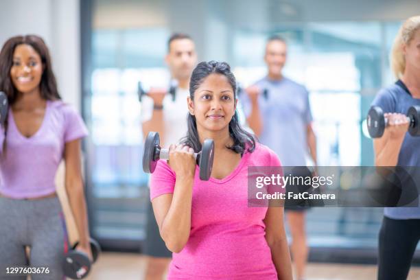 pregnant woman at group fitness class - ymca stock pictures, royalty-free photos & images