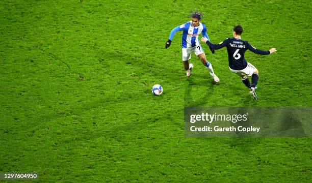 Juninho Bacuna of Huddersfield Town is challenged by Shaun Williams of Millwall during the Sky Bet Championship match between Huddersfield Town and...