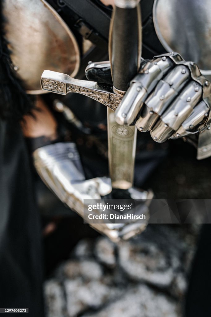 Close up of hand and sword of a medieval fantasy knight