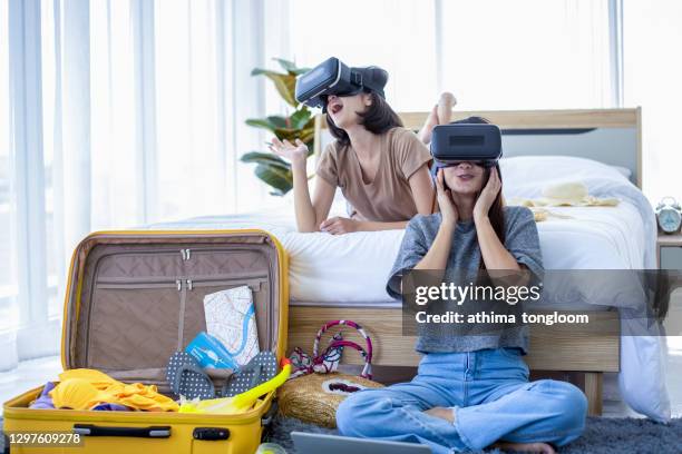 asian couple girl playing a vr device at home. - virtual vacations stock pictures, royalty-free photos & images