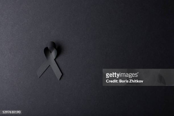black awareness ribbon. - mourning stock-fotos und bilder