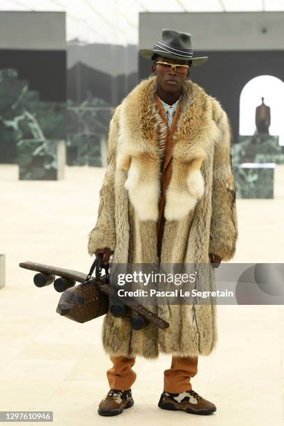 In this image released on January 21st, a model walks the runway during the Louis Vuitton Menswear Fall/Winter 2021-2022 show as part of Paris...