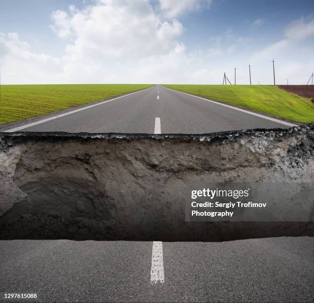 broken road with cracked asphalt - earthquake road stock pictures, royalty-free photos & images