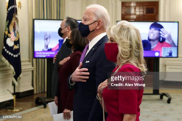 President Joe Biden , first lady Dr. Jill Biden , Vice President Kamala Harris and Second Gentleman Doug Emhoff listen to the national anthem as they...