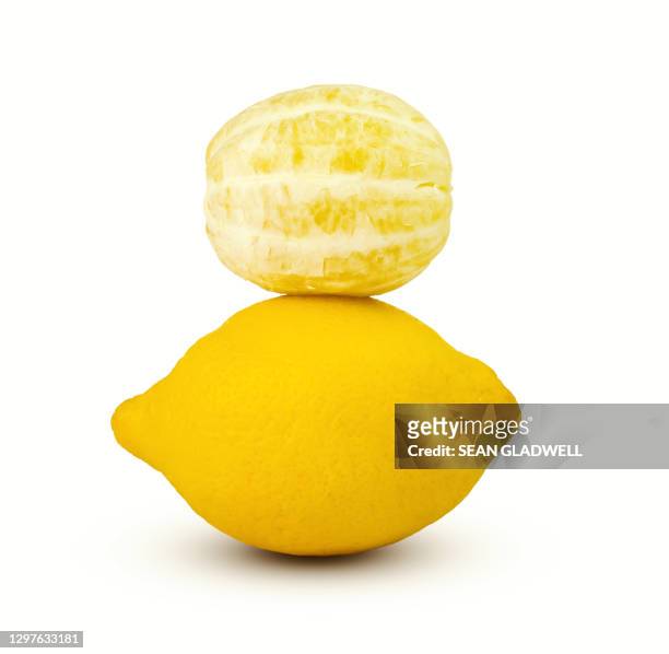 lemon balanced on white background - peeled stock pictures, royalty-free photos & images