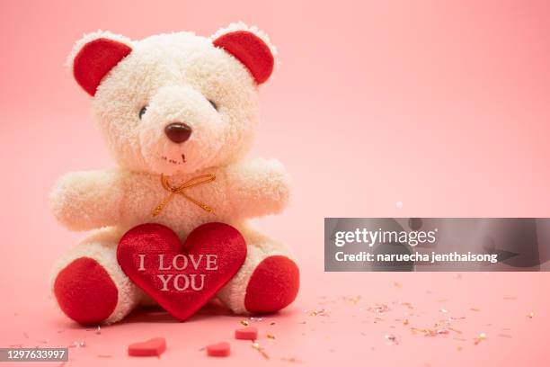 teddy bear with big red heart isolated on pink background. valentines day concept with copy space - happy valentines day stock pictures, royalty-free photos & images