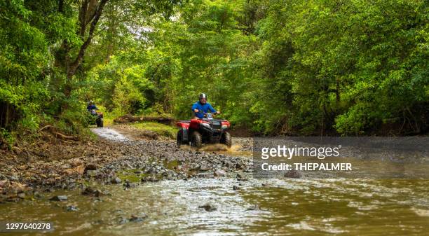 man driving quad bike in costa rica - atv riding stock pictures, royalty-free photos & images
