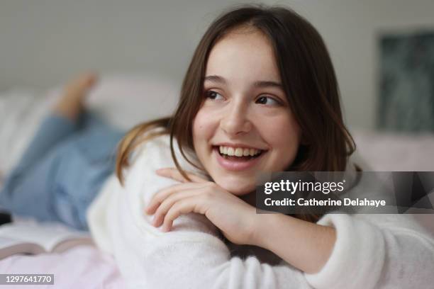 portrait of a 15 years old girl smiling in her room - 14 15 years girl stock pictures, royalty-free photos & images