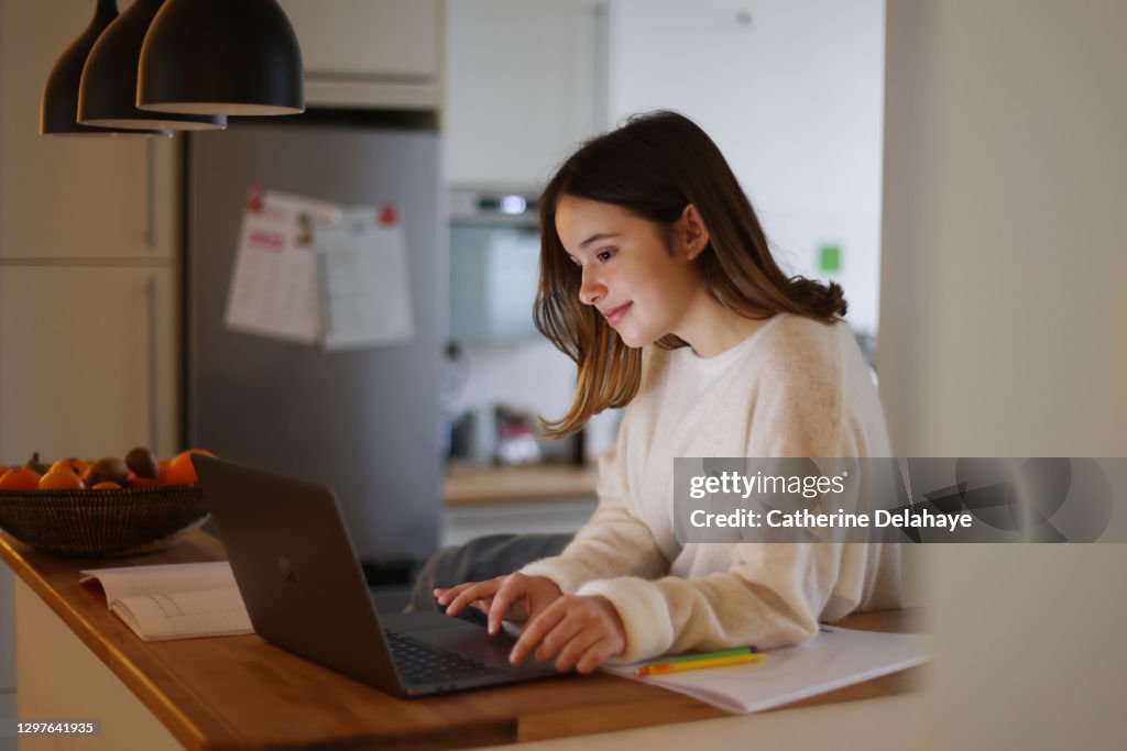 A 15 years old girl attending online school classes from home