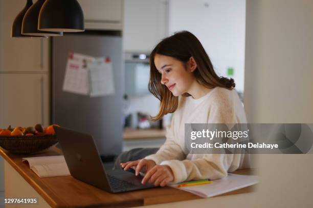 a 15 years old girl attending online school classes from home - teen computer fotografías e imágenes de stock