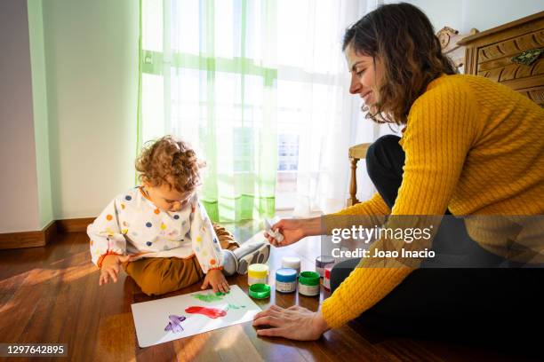 toddler boy painting at home - baby gender reveal stock pictures, royalty-free photos & images