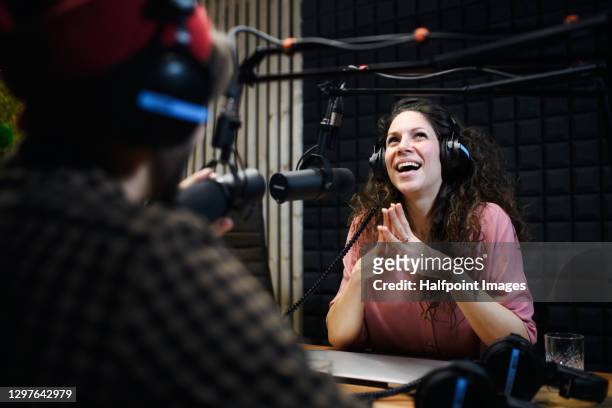 young woman and man makes a podcast audio recording in a studio. - content stock pictures, royalty-free photos & images