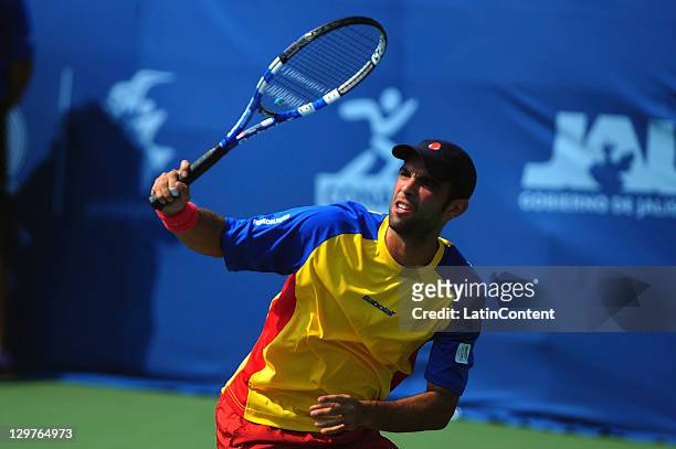 Juan Sebastian Cabal of Colombia returns the ball to Brazil's Rogerio Dutra deTenis Male party during 2011 Pan American Games in the complex Telcel...