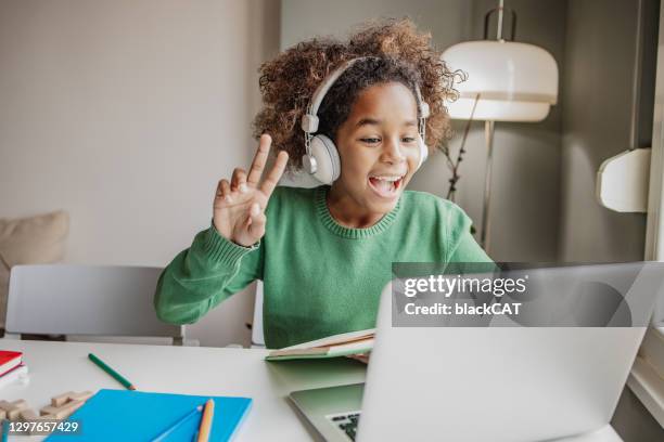 little girl is communicating on a video call with teacher - games workshop stock pictures, royalty-free photos & images