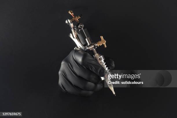 tattoo machine - black glove stock pictures, royalty-free photos & images