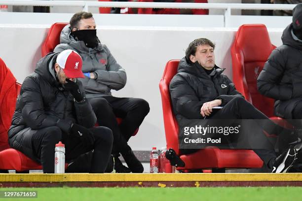 Jurgen Klopp, Manager of Liverpool reacts as his assistant, Peter Krawietz looks on during the Premier League match between Liverpool and Burnley at...