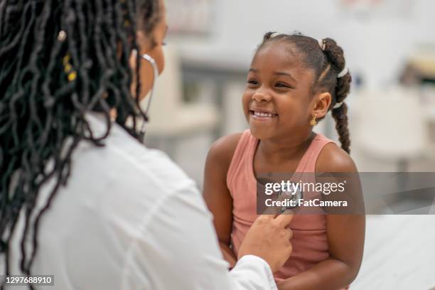 let's take a listen to how strong your heartbeat is - african american children stock pictures, royalty-free photos & images