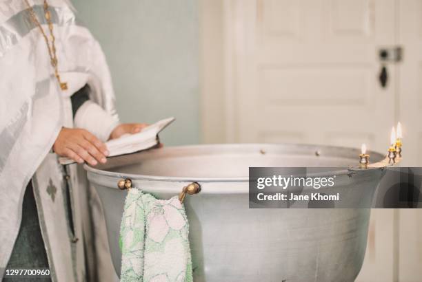 bathtub for baptism and candles - baptism stock pictures, royalty-free photos & images