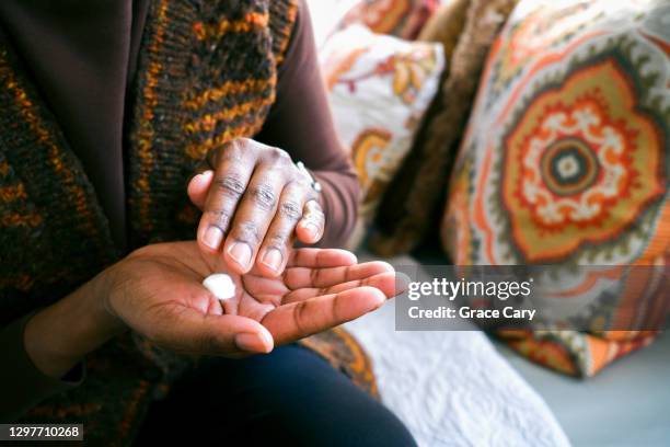 woman moisturizes hands - handkräm bildbanksfoton och bilder