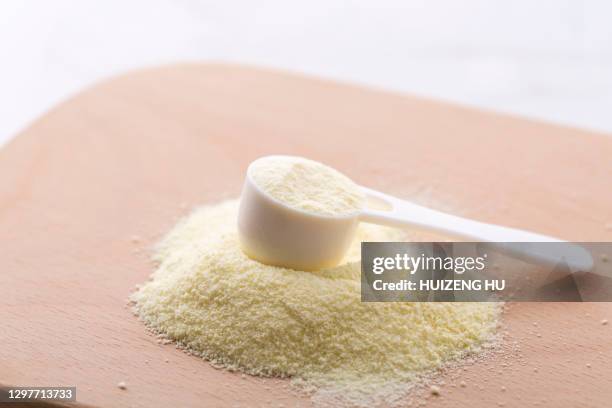 powdered milk in spoon - milchpulver stock-fotos und bilder