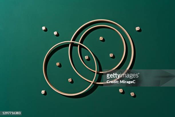 crossing wooden rings border and dices - exclusion concept stock pictures, royalty-free photos & images