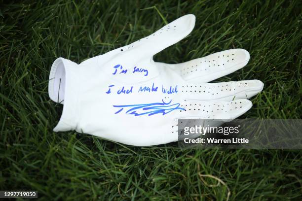 Glove signed by Tommy Fleetwood of England for a marshal on the 18th hole is pictured during Day 2 of the Abu Dhabi HSBC Championship at Abu Dhabi...