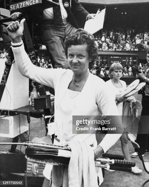 Betty Stove of the Netherlands gives the thumbs up sign after defeating Sue Barker of Great Britain who looks on behind following their Women's...