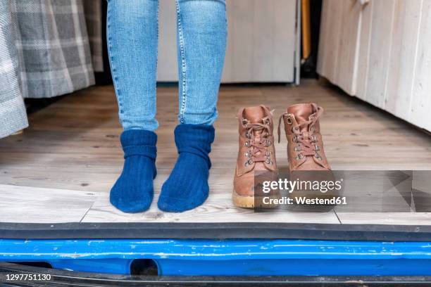 female feet and boots at the door of a camper van - stockings feet stock pictures, royalty-free photos & images