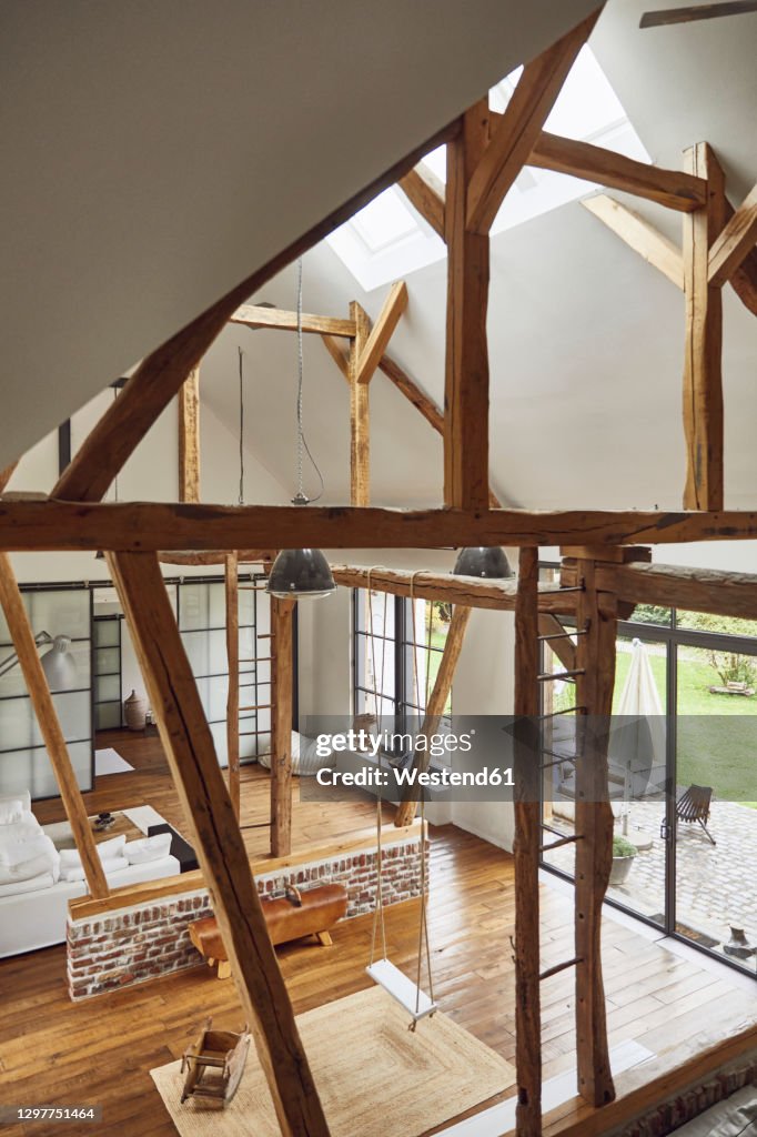Wooden roof beams in living room at home