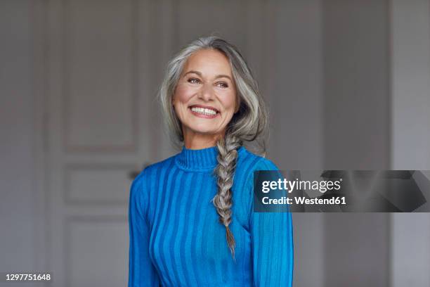 happy mature woman looking away at home - beautiful braid stockfoto's en -beelden