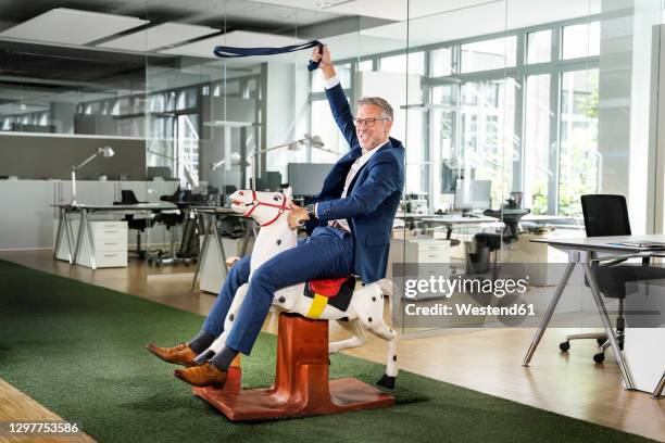 Man Riding Rocking Horse 595 Adult Rocking Horse Stock Photos, High-Res Pictures, and Images ...