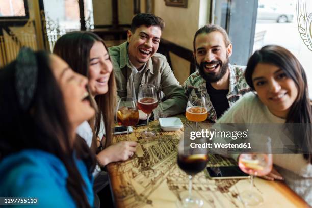 male and female friends laughing while taking selfie in bar - bar girl stock pictures, royalty-free photos & images