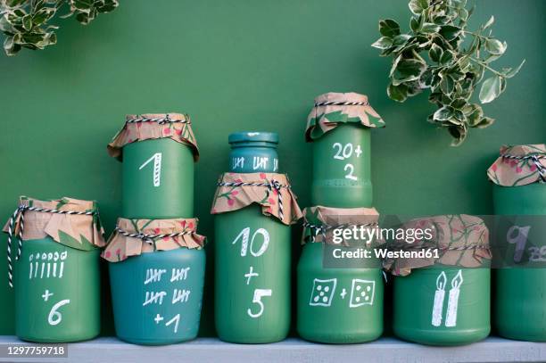 diygreen painted jars representing advent calendar - advent fotografías e imágenes de stock