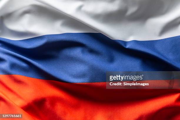 russia flag blowing in the wind. - flagge stock-fotos und bilder