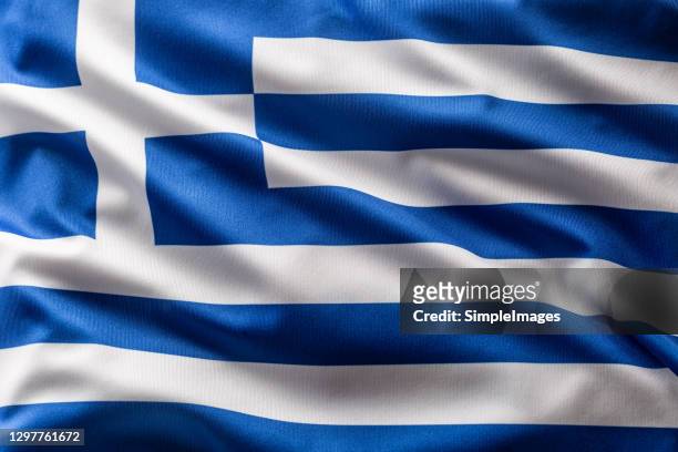 greece flag blowing in the wind. - greece flag stock pictures, royalty-free photos & images