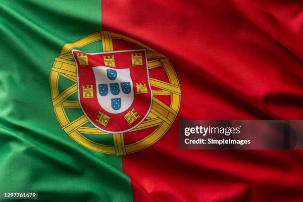 flag portugal of blowing in the wind. - portuguese flag stock pictures, royalty-free photos & images