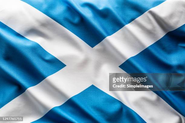 flag of scotland blowing in the wind. - scotland flag stock pictures, royalty-free photos & images
