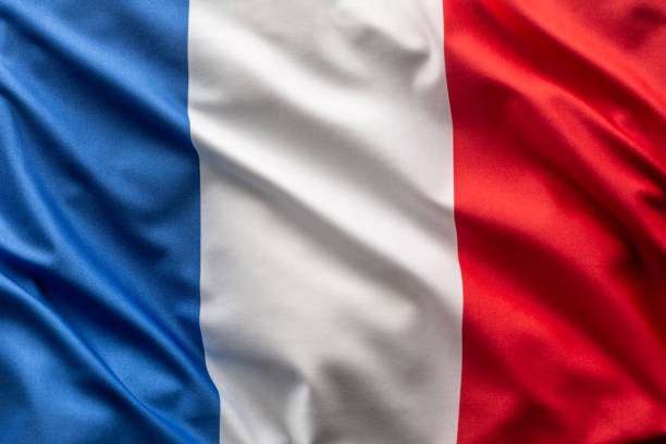 flag of france blowing in the wind. - france flag stock pictures, royalty-free photos & images