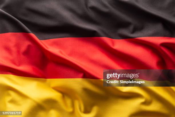 flag of germany blowing in the wind. - bandiera tedesca foto e immagini stock