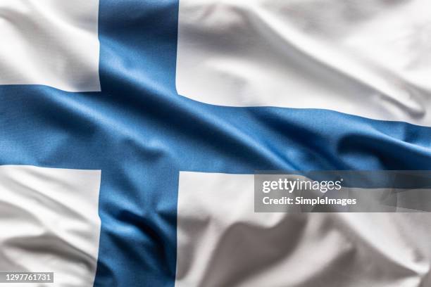 flag of finland blowing in the wind. - finland stockfoto's en -beelden