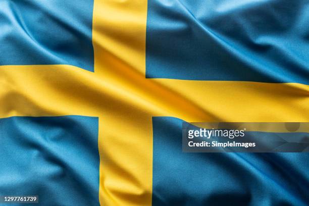 flag of sweden blowing in the wind. - suécia fotografías e imágenes de stock