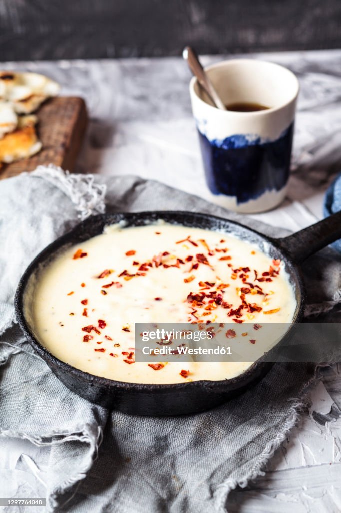 Kuymak in cooking pan on table