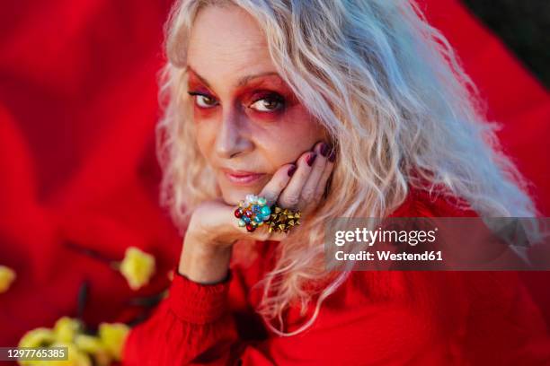 fashionable senior woman with hand on chin - long bright yellow dress stock pictures, royalty-free photos & images