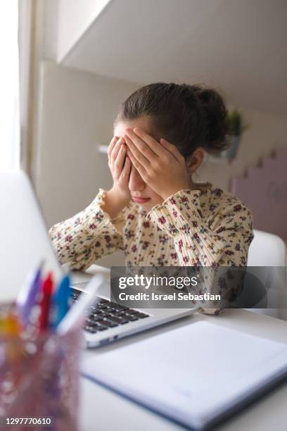 close-up view of a girl covering her face with her hands out of frustration and stress for the schoolwork - school exercise book cover stock pictures, royalty-free photos & images