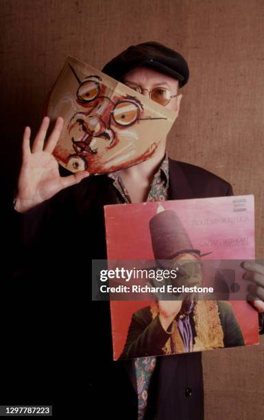 Andy Partridge of English rock band XTC, portrait, holding up a copy of Captain Beefheart's Trout Mask Replica album, 2000.