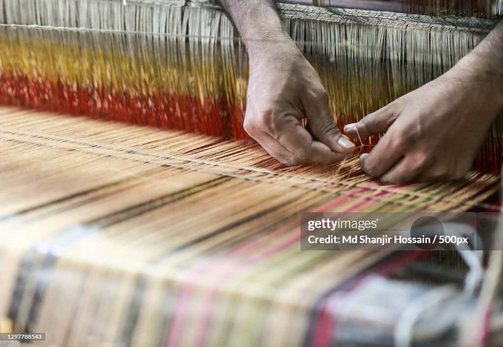 Cropped hands working with loom in textile factory,Kalihati,Bangladesh