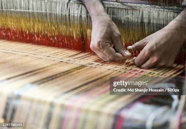 cropped hands working with loom in textile factory,kalihati,bangladesh - textielfabriek stockfoto's en -beelden