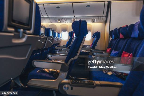 empty seats in a commercial aircraft - armrest stock pictures, royalty-free photos & images