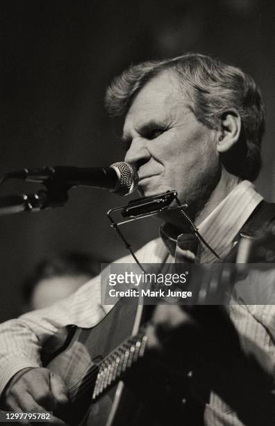 North Carolinian guitarist and folksinger Doc Watson plays his guitar and harmonica at the Sundance Saloon on October 13, 1985 in Fort Collins,...